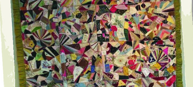 Multi-coloured, with olive green silk back and a ruffled border, this crazy quilt dates from the 1880s.